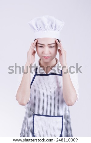 Chef headache and stress at work. Woman baker, chef or cook tired stressed and overworked with stress.