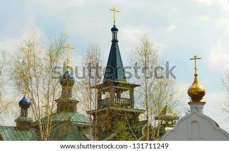 Easter crosses and domes of church and spring leaves