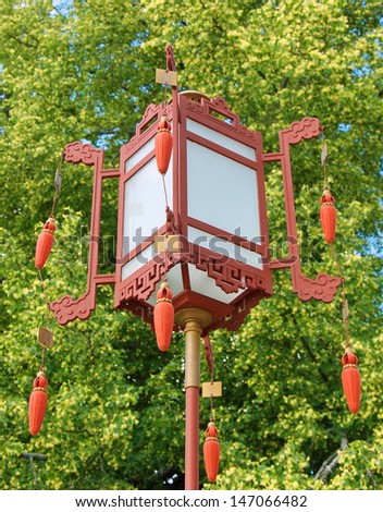 Chinese red lantern with tassels on a green background