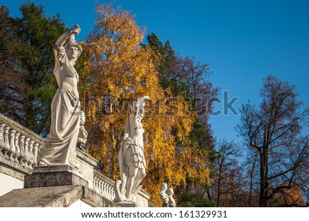 Antique sculptures in the ancient autumn park