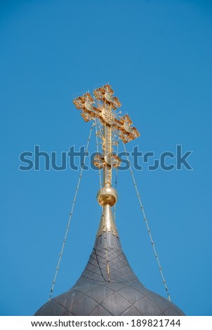 Openwork gold Orthodox Christian cross on the church dome