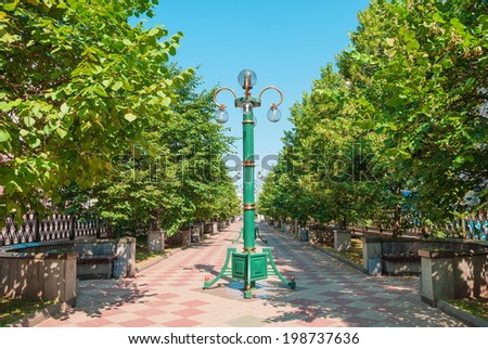 Park with green trees and a lantern in Minsk