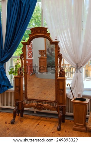 Antique mirror in a wooden carved frame
