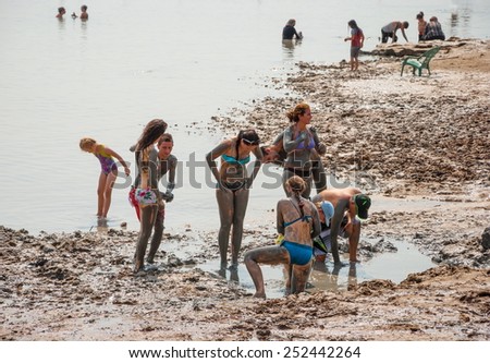 People on the shore of the Dead Sea are taking wellness treatments using the curative mud from the Dead Sea salts. Israel, Dead Sea, beach Kalia. October 9, 2014