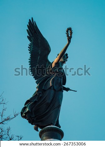 Sculpture of the winged goddess of victory Nike on the background of blue sky
