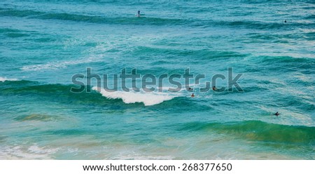 Seascape with waves. People are surfing.