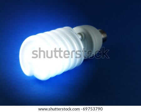 Shining light bulb on the blue background