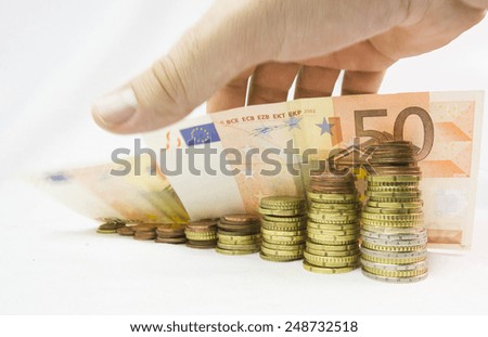 pile of euros money like graph, , hand  putting coins, blur