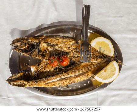 mullet - open roasted fish lemon dish - food of west Greece called \