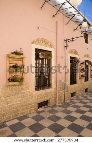 windows street flowers in Ioannina city, Greece -  patio like chess , old street