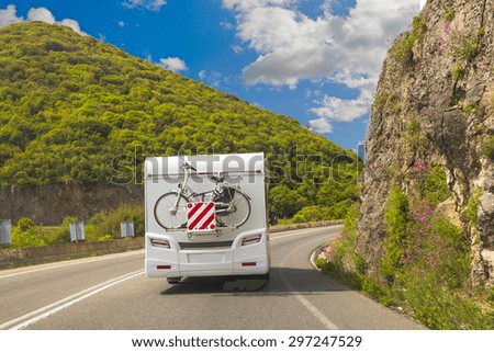 caravan road - bike, back side - green trees blue sky and clouds