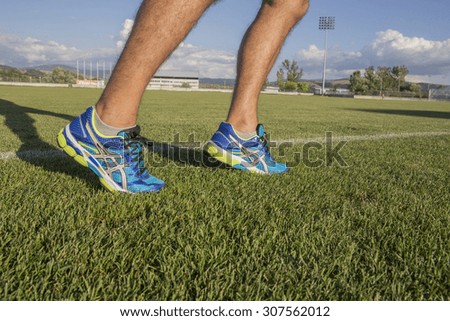 men running on the grass, shoes , close up