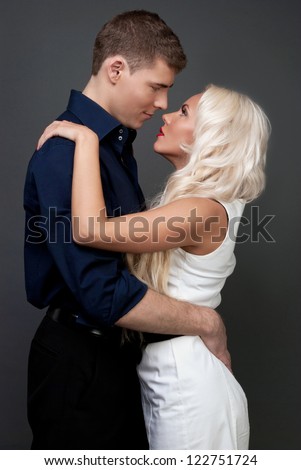 Man and woman blonde, love, feelings, sexy - the modern concept of love story. Hug of love and passion. Gentle kiss a sign of love. Men, women relations between. Men and women love passion betrayal.
