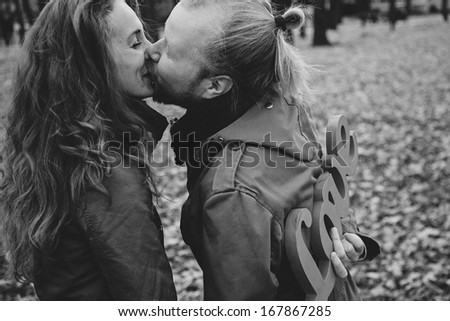 black and white picture. Two young lovers and beautiful people for a walk in the park. Autumn Love Story two. Woman and a man with a beard. Keep love in hands. Writing and love letters. I love you.