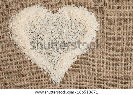 Rice grains in a heart shape. Rice is put in the form of heart sign of health and healthy food.