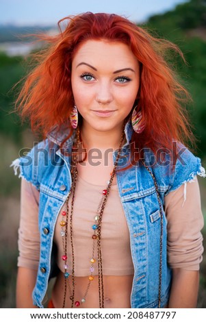 Portrait of charming young red haired girl. Beautiful smile from young woman. Sunset summer sun. Fresh air, happiness, joy, youth, beauty - the concept of advertising on the health of happy people.