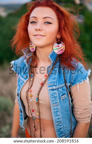 Portrait of charming young red haired girl. Beautiful smile from young woman. Sunset summer sun. Fresh air, happiness, joy, youth, beauty - the concept of advertising on the health of happy people.