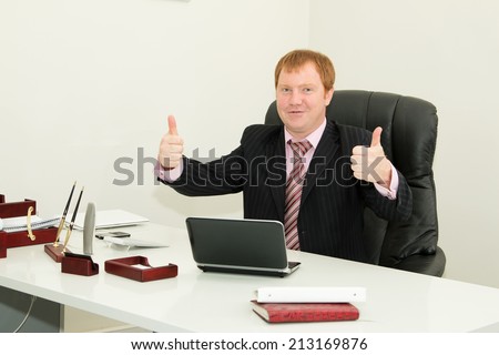 Business man, employee sitting at his desk. Company director, head of department, in the workplace in the business office. Manager, notebook, office, work, desk, documents, work - concept processes.