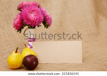 Autumn bouquet of chrysanthemum flowers in a white vase. Autumn colors maroon red. Flowers in a vase on the table - an autumn mood. Pink flower - Image for postcards.