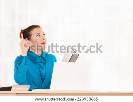 Female office worker working at a desk in an office building.