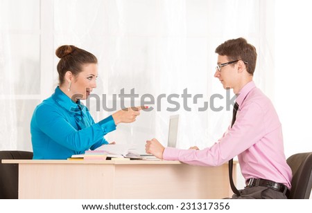 Man and woman - a job interview or business meeting. Male student came to the office to get a job. HR Manager conducts the first interview. Agree on. Discuss the possibilities of business cooperation.