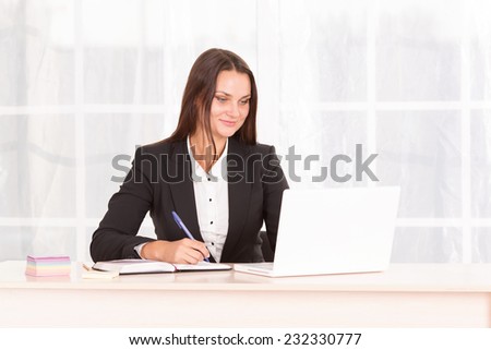 Modern office employee. Business woman working at office table on his laptop. Computer, internet, business, adverse communication - business concept and way of life of the office staff. She is student