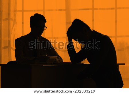 Silhouettes of business people on orange sunset. Negotiations. Relations in the team of employees of one company. Situation on the market. Difficulties in the work. Reprimanded the head.