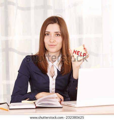 Help. Woman aspiring office staff at work in the office. She works at his laptop. The girl secretary or office manager sitting at the table on time of the day. Young girl student  asks for help.