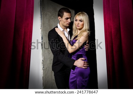 Love, passion, jealousy, loyalty, feelings, sex - emotions loving couple. Beginning of a Love Story. Young couple in love. Loving couple standing in doors together while woman hugging her boyfriend.
