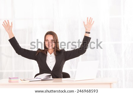 Female student. Modern business woman working in bright office. Manager, secretary. Woman in the office of the company. The fitness in the workplace. Office fitness. Raise their hands to the top.