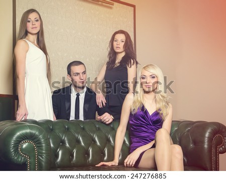 Complicated love relationship. Party in a closed club. One man and three women. The man next to the women in the room. Love triangle. The concept of modern bachelor lifestyle. Love story four people.