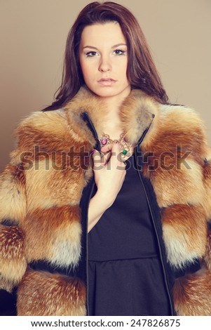 Vintage. Beautiful woman with fur. Portrait of a beautiful young woman with fur hat. Young woman with fur. Fashion woman in fur coat, lady. Golden fox fur.