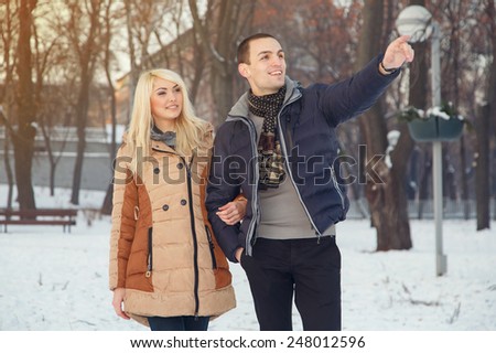 Couple of lovers in the city park a love story. Winter, tourism, leisure, love story. Joint walk through the winter town. Romantic happy urban couple Stylish urban young man and woman on travel Europe