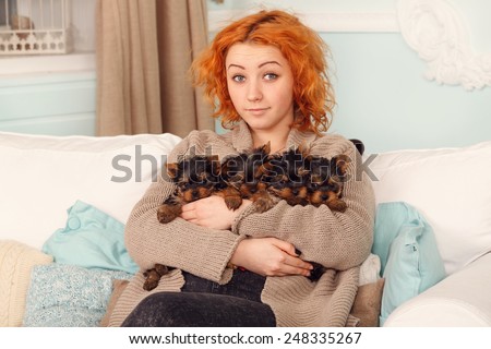 Young woman with four puppies, cute Yorkshire terrier. When the puppies were in the home, all the people care for them. Girl with Yorkshire four pups. Best friend. Yorkshire puppy. Very small puppies
