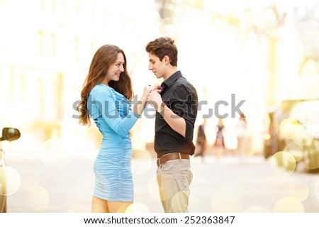 Declaration of love. Young happy couple in the city. Young man and beautiful woman on street at dating. Walking through the city day.  Love between two people. Honeymoon. Love story series