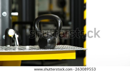 Gym. Gymnasium with sports equipment. Dumbbells, barbells, dumbbells - equipment to work on muscle mass. Morning exercises for vitality afternoon. In modern sports club. Weight training equipment.