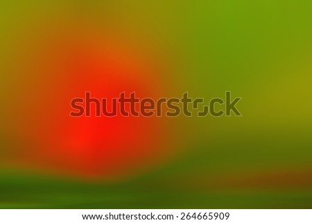 Blurred image background. Bright colored wallpaper. Red spot in the middle. Red, yellow, green - the basic color of the blurred photos. Field, forest, flowers, sun, light in the form of diffuse spots.