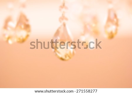 Blurred background image for the screen saver with the text. Photo in pastel shades with decorative chandeliers element with large crystals. The substrate for the text. Chandelier crystal faceted.