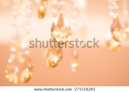 Blurred background image for the screen saver with the text. Photo in pastel shades with decorative chandeliers element with large crystals. The substrate for the text. Chandelier crystal faceted.