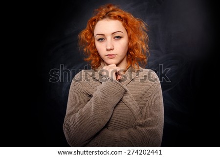 Sad woman. Young girl with a very sad expression on her face. Girl student thought about something. Emotional portrait sad woman. Young woman standing tilt head, has got an headache. Black background.