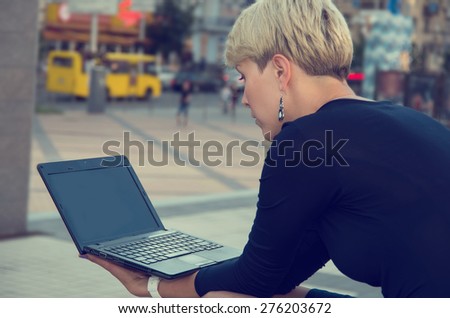 Business woman working with a laptop on the street city. Working in the office do not. Consultant in the working process. Private business.. Businessman working at laptop. City businesswoman working.