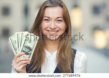 Woman with us dollar money. Business woman holding money. Woman and money. Young business woman holding a lot of USA hundred dollar bills. Business woman has earned a good amount of dollars.