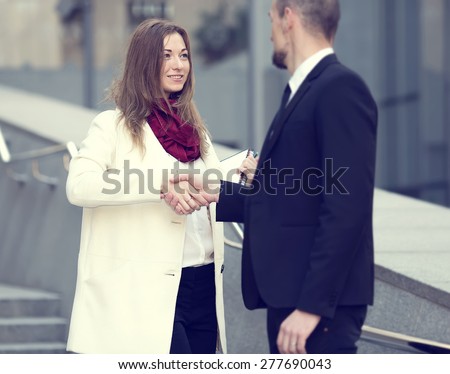 Welcoming business woman giving a handshake. Business contract. Business people. Business meeting. Meet the client. Business communication between man and woman. Business woman the focus of attention.