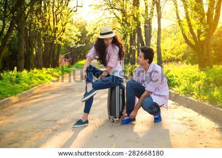 Happy travel, man and woman. Traveling, holidays, vacation, love story and friendship concept - smiling couple having fun in park. Loving couple in countryside. Love story. Happy people having fun.