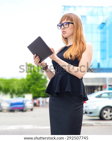 Businesswoman on break in park. Young professional business woman using tablet computer. Pretty business woman in working using digital tablet outdoors. Woman student mixed race. Smiling student girl.
