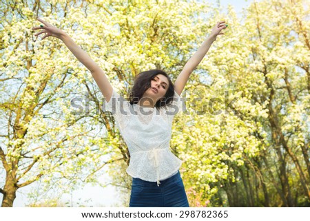 Portrait of a beautiful young Caucasian woman outdoor. Freedom happy woman Enjoying nature. Beauty girl Outdoor. Freedom concept. Beauty girl over sky, nature and sun. Sun dreams. Enjoyment. Lifestyle