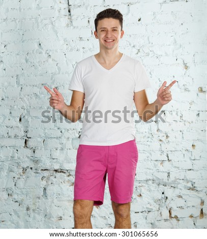 Portrait of happy smiling man. Happy man smiling - friendly face. Young cheerful man in a white shirt shows smile. Young handsome man smiling. Male model looking at camera. Copy space.