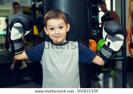 Boy boxer. Sport. Boy champion - boxing, fitness,  Young boy standing by bag boxing. Boy has been in the gym for boxing. Young man in a sports hall near the bag for boxing. Prepare for competitions.