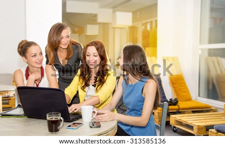 Four female students and young office workers. Discussion of joint work on the project. The team of women. Female business. Women working in the office. Group of women of different ages and nations.