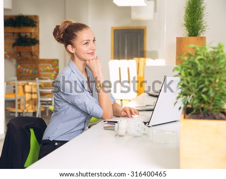 Woman dreaming. Woman dreaming. Business woman dreams she is in the office. Business woman in office. Young business woman using laptop at office.